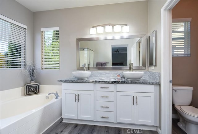 38919 Hickory Hill Ct, Murrieta, CA 92563 - bathroom with double vanity, wood finished floors, and a garden tub