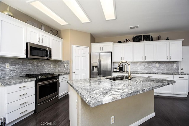38919 Hickory Hill Ct, Murrieta, CA 92563 - kitchen featuring stainless steel appliances, dark wood-style floors, backsplash, and white cabinetry