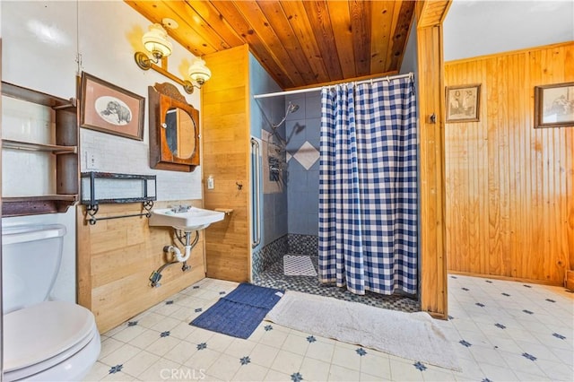 56225 Moonstone Ln, Yucca Valley, CA 92284 - bathroom featuring toilet, wooden walls, a tile shower, wood ceiling, and a sink