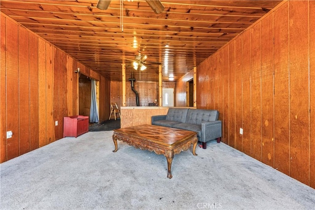 56225 Moonstone Ln, Yucca Valley, CA 92284 - living room with a ceiling fan, carpet, wood walls, and a wood stove
