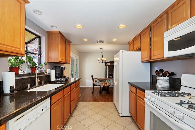 9614 Peach Ave, Hesperia, CA 92345 - kitchen featuring white appliances, recessed lighting, light tile patterned floors, brown cabinets, and a chandelier