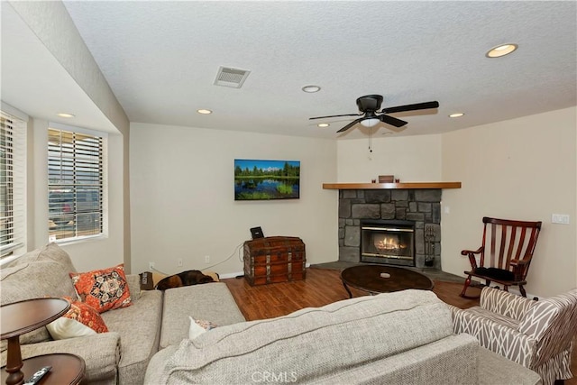 9614 Peach Ave, Hesperia, CA 92345 - living area with wood finished floors, recessed lighting, a stone fireplace, and a ceiling fan