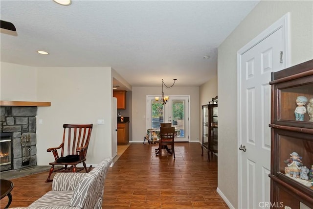 9614 Peach Ave, Hesperia, CA 92345 - living room featuring dark wood-style floors, a fireplace, recessed lighting, and a chandelier