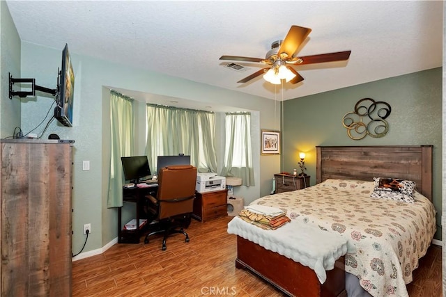 9614 Peach Ave, Hesperia, CA 92345 - bedroom with wood finished floors, a desk, and a ceiling fan