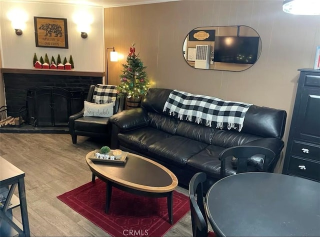 918 W Aeroplane Blvd, Big Bear City, CA 92314 - living room featuring wood finished floors, crown molding, and a fireplace