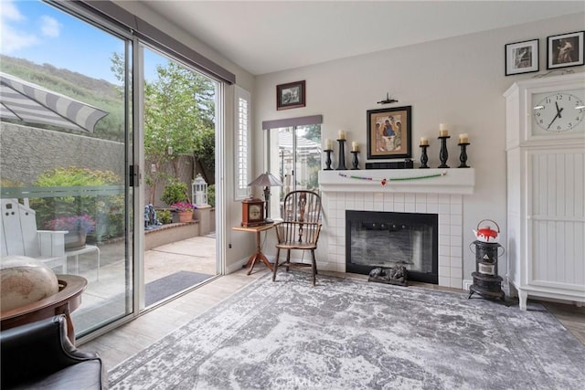 2141 Triador St Unit 103, Corona, CA 92879 - sitting room with wood finished floors and a tile fireplace