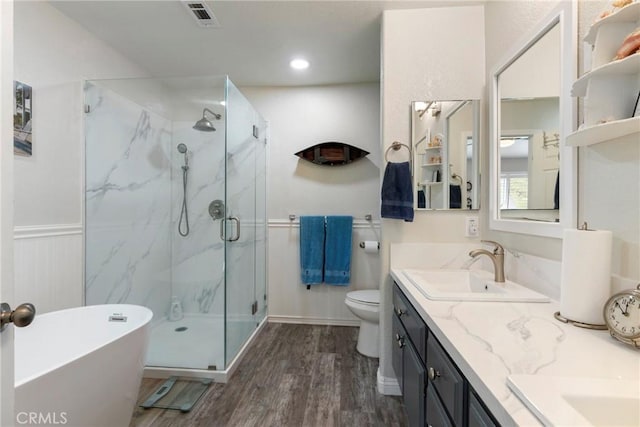 2141 Triador St Unit 103, Corona, CA 92879 - full bathroom featuring a marble finish shower, double vanity, a freestanding bath, wood finished floors, and toilet