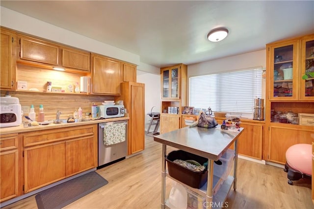 866 Brighton Ave, Grover Beach, CA 93433 - kitchen with dishwasher, a sink, light wood-style flooring, white microwave, and light countertops