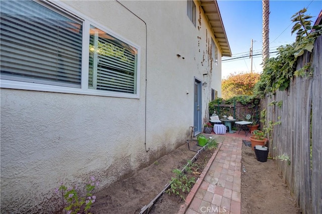 866 Brighton Ave, Grover Beach, CA 93433 - view of side of home featuring stucco siding and a patio area