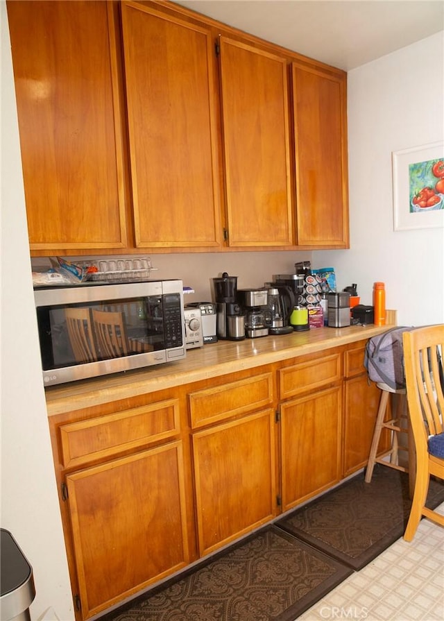 866 Brighton Ave, Grover Beach, CA 93433 - kitchen featuring stainless steel microwave, light countertops, and brown cabinetry