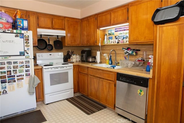 866 Brighton Ave, Grover Beach, CA 93433 - kitchen featuring white appliances, under cabinet range hood, light countertops, brown cabinets, and light flooring
