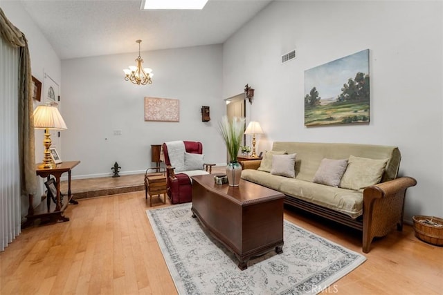 20121 Swansea Ln, Huntington Beach, CA 92646 - living area with vaulted ceiling, a chandelier, light wood finished floors, and baseboards