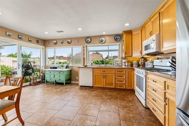 20121 Swansea Ln, Huntington Beach, CA 92646 - kitchen with white appliances, a sink, recessed lighting, light tile patterned flooring, and light countertops