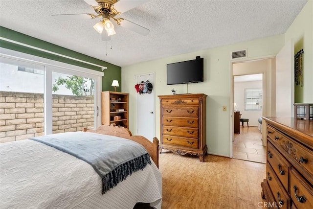 20121 Swansea Ln, Huntington Beach, CA 92646 - bedroom with a textured ceiling, light wood-type flooring, and a ceiling fan
