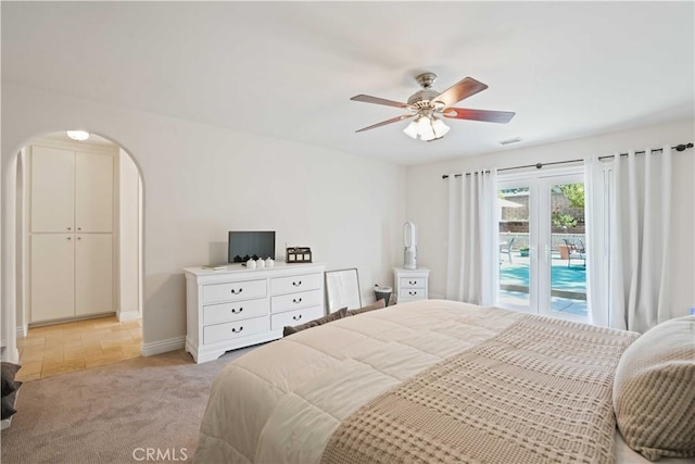 23538 Arlen Dr, Newhall, CA 91321 - bedroom with access to outside, arched walkways, light carpet, baseboards, and ceiling fan