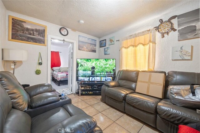 11100 S Normandie Ave, Los Angeles, CA 90044 - living room featuring a textured ceiling, light tile patterned flooring, and a textured wall