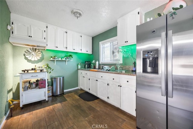 11100 S Normandie Ave, Los Angeles, CA 90044 - kitchen with stainless steel fridge, white cabinetry, dark wood finished floors, baseboards, and a textured ceiling