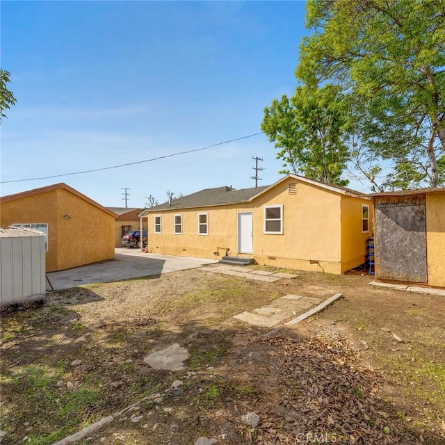 11100 S Normandie Ave, Los Angeles, CA 90044 - back of house with stucco siding, crawl space, and a patio