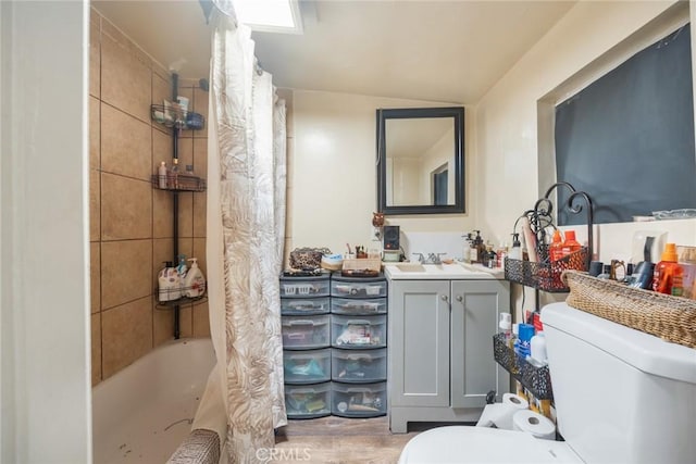 11100 S Normandie Ave, Los Angeles, CA 90044 - bathroom featuring toilet, vanity, shower / tub combo, vaulted ceiling, and wood finished floors