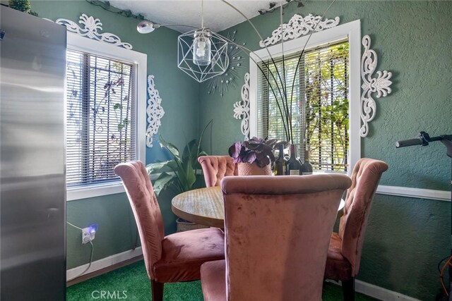 11100 S Normandie Ave, Los Angeles, CA 90044 - dining area with carpet, baseboards, and a textured wall