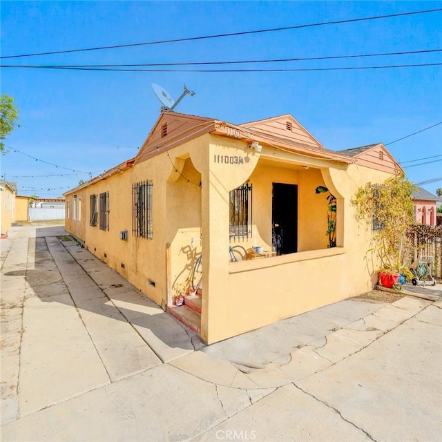 11100 S Normandie Ave, Los Angeles, CA 90044 - view of side of home featuring stucco siding