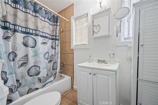 11100 S Normandie Ave, Los Angeles, CA 90044 - full bathroom with shower / bath combination with curtain, toilet, vanity, tile patterned floors, and a textured ceiling