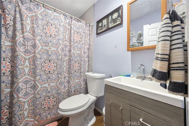 11100 S Normandie Ave, Los Angeles, CA 90044 - bathroom with toilet, vanity, and curtained shower