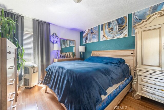 11100 S Normandie Ave, Los Angeles, CA 90044 - bedroom with wood finished floors and a textured ceiling