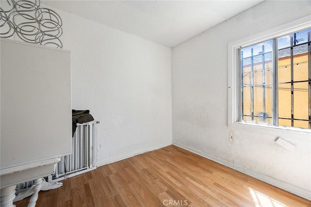 11100 S Normandie Ave, Los Angeles, CA 90044 - empty room with wood finished floors and baseboards