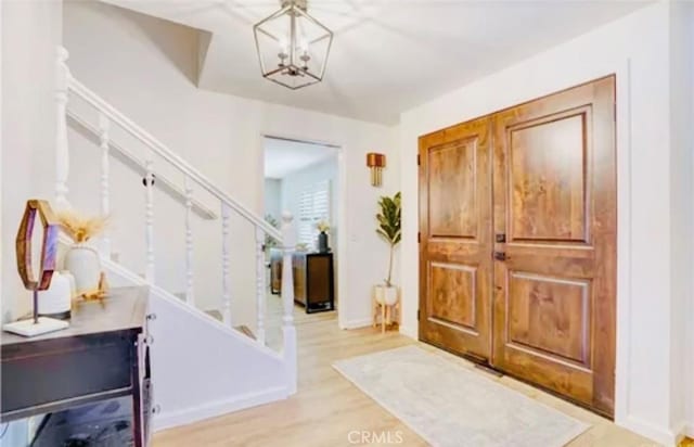 564 Northpark Blvd, San Bernardino, CA 92407 - foyer featuring stairs, a chandelier, baseboards, and wood finished floors