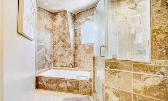 564 Northpark Blvd, San Bernardino, CA 92407 - bathroom featuring a garden tub, a shower stall, tile walls, and tile patterned flooring