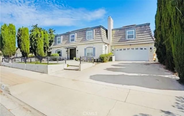 564 Northpark Blvd, San Bernardino, CA 92407 - view of front of property with driveway, an attached garage, and a chimney