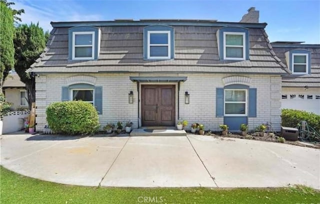 564 Northpark Blvd, San Bernardino, CA 92407 - second empire-style home featuring mansard roof, a chimney, and brick siding