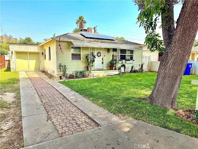 858 Bussey St, San Bernardino, CA 92405 - bungalow featuring a front lawn, solar panels, concrete driveway, and a chimney