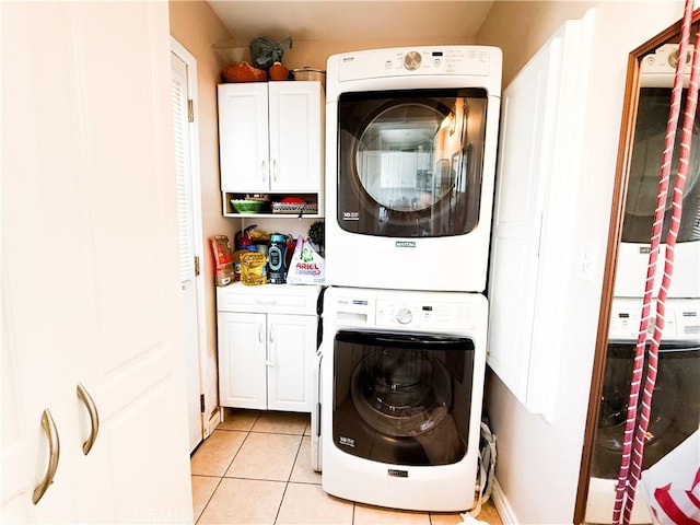858 Bussey St, San Bernardino, CA 92405 - washroom featuring cabinet space, stacked washer / drying machine, and light tile patterned flooring