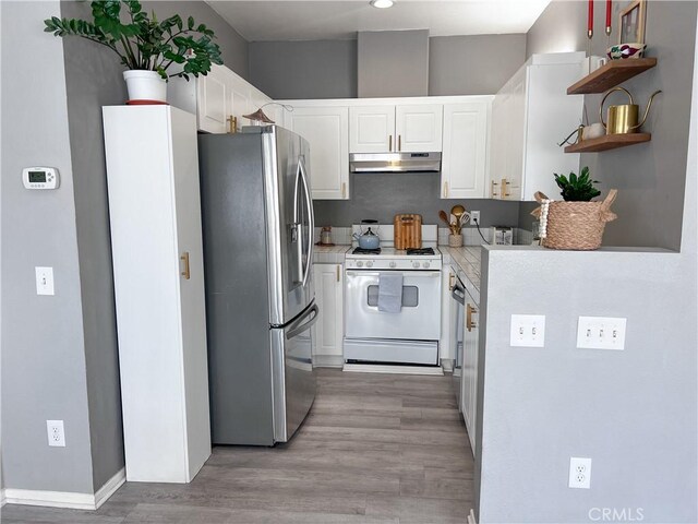 26959 Hillsborough Pkwy, Unit Valencia, CA 91354 - kitchen featuring stainless steel refrigerator with ice dispenser, under cabinet range hood, white gas range, light countertops, and open shelves