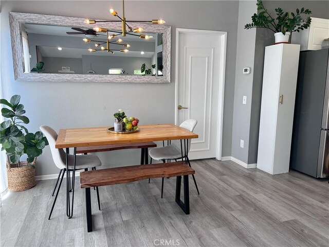 26959 Hillsborough Pkwy, Unit Valencia, CA 91354 - dining area with baseboards, wood finished floors, and a chandelier