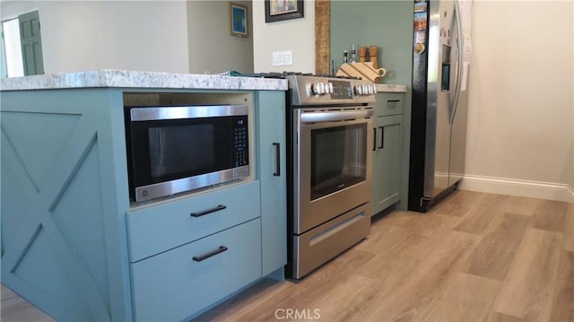 6214 Granby Ave, Rancho Cucamonga, CA 91737 - kitchen featuring stainless steel appliances, light wood-style floors, and baseboards