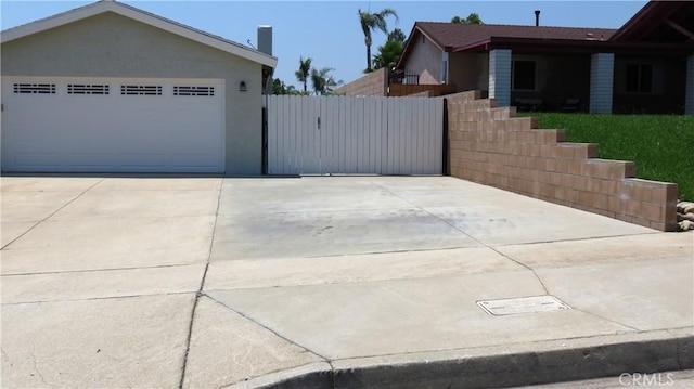 6214 Granby Ave, Rancho Cucamonga, CA 91737 - view of home's exterior with a gate, a garage, and driveway