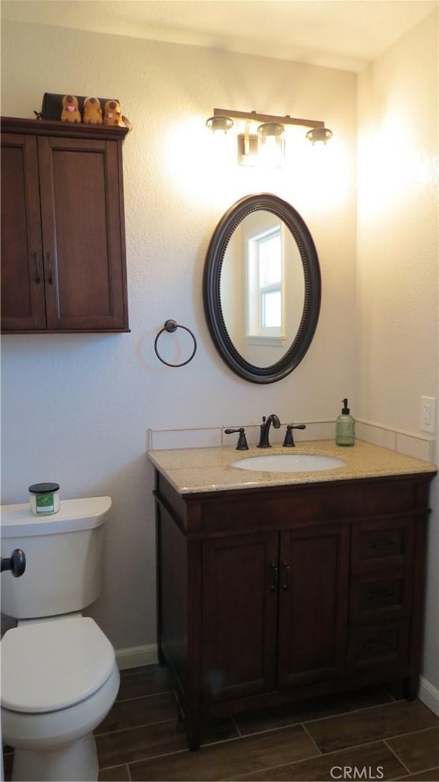 6214 Granby Ave, Rancho Cucamonga, CA 91737 - bathroom with vanity, wood tiled floors, toilet, and baseboards