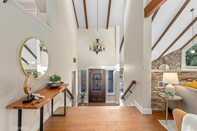 2363 Via Cielo, Hacienda Heights, CA 91745 - foyer with high vaulted ceiling, a chandelier, beamed ceiling, hardwood / wood-style flooring, and baseboards