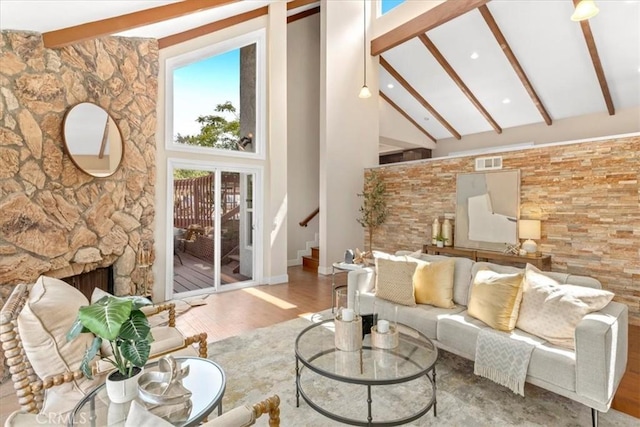 2363 Via Cielo, Hacienda Heights, CA 91745 - living area featuring beamed ceiling, wood finished floors, high vaulted ceiling, a stone fireplace, and stairs