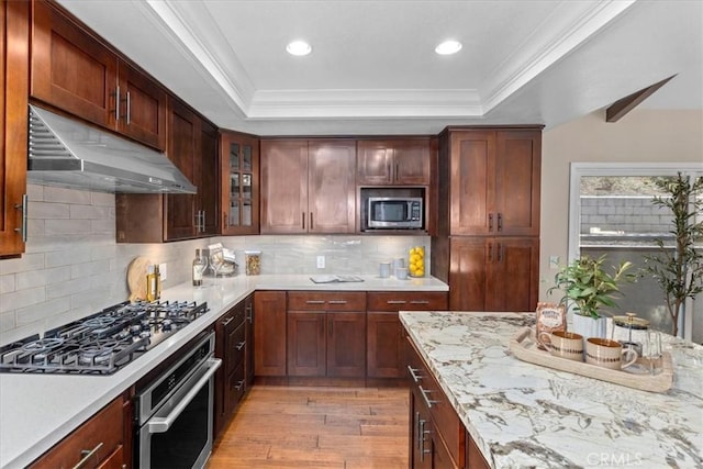 2363 Via Cielo, Hacienda Heights, CA 91745 - kitchen featuring appliances with stainless steel finishes, under cabinet range hood, light wood-style floors, crown molding, and glass insert cabinets