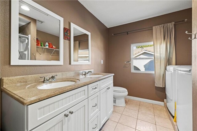 28642 Apricot Pl, Saugus, CA 91390 - full bath featuring washer and clothes dryer, toilet, double vanity, baseboards, and tile patterned flooring