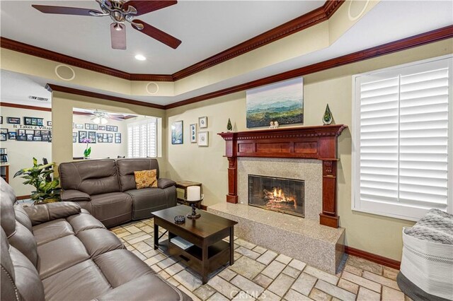 28642 Apricot Pl, Saugus, CA 91390 - living room with ceiling fan, crown molding, a high end fireplace, baseboards, and stone tile floors