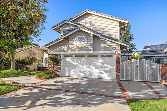 28642 Apricot Pl, Saugus, CA 91390 - traditional home featuring brick siding, driveway, a gate, and a garage