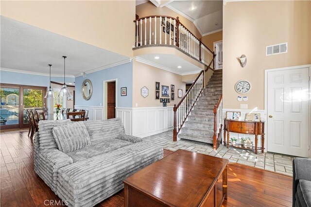 28642 Apricot Pl, Saugus, CA 91390 - living room with a towering ceiling, stairs, ornamental molding, wood finished floors, and a wainscoted wall