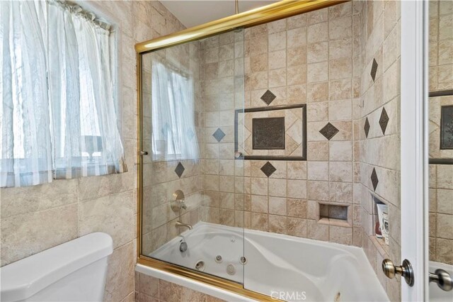 28642 Apricot Pl, Saugus, CA 91390 - bathroom featuring a combined bath / shower with jetted tub, toilet, and tile walls