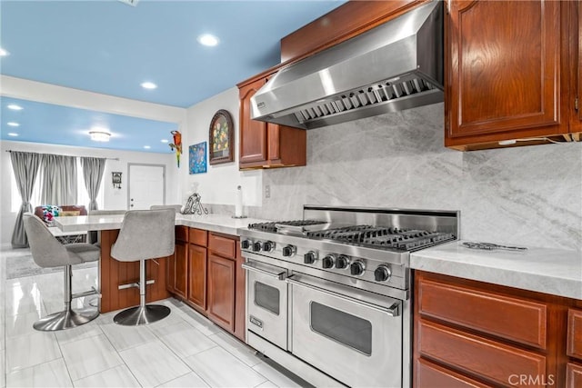 3133 W 187th Pl, Torrance, CA 90504 - kitchen featuring range with two ovens, wall chimney exhaust hood, a peninsula, light countertops, and recessed lighting