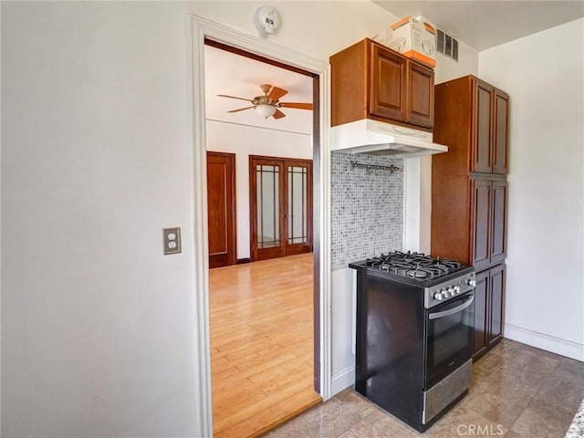 1030 E Ocean Blvd Unit 403, Long Beach, CA 90802 - kitchen with stainless steel gas range oven, range hood, tasteful backsplash, ceiling fan, and baseboards